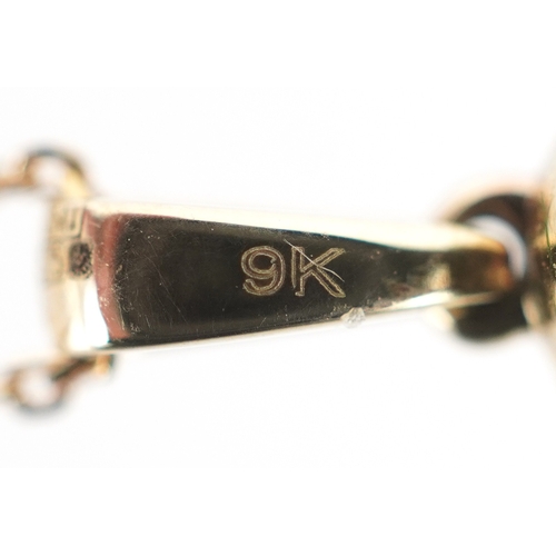 3206 - A 9K gold emerald and diamond cluster pendant on a 9K gold necklace, total diamond weight 0.19 carat... 