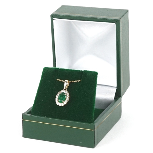 3206 - A 9K gold emerald and diamond cluster pendant on a 9K gold necklace, total diamond weight 0.19 carat... 
