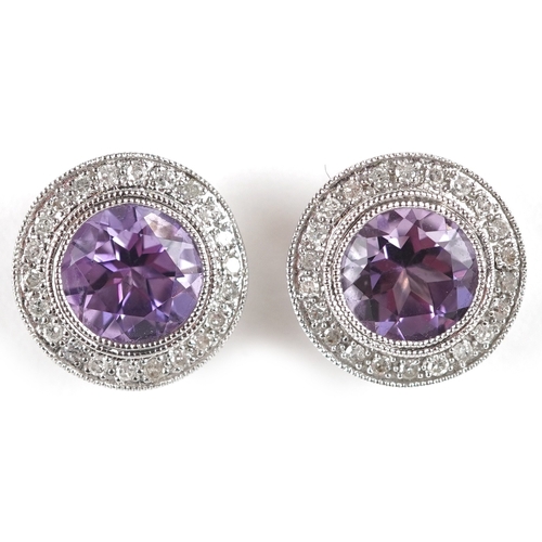 3085 - A pair of 9ct white gold amethyst and diamond cluster earrings, total diamond weight approximately 0... 