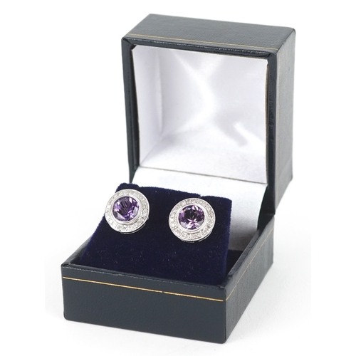 3085 - A pair of 9ct white gold amethyst and diamond cluster earrings, total diamond weight approximately 0... 