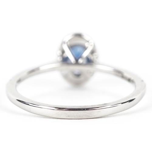 3155 - A platinum sapphire and diamond cluster ring with diamond set shoulders, total diamond weight 0.18 c... 