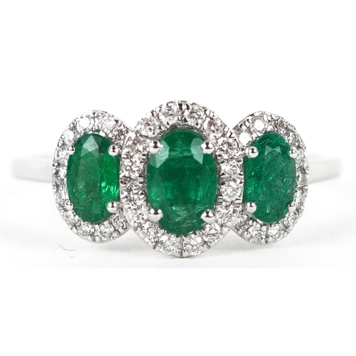 3177 - A platinum emerald and diamond trilogy ring, total diamond weight 0.22 carat, total emerald weight 0... 
