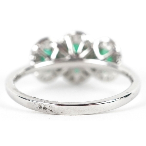 3177 - A platinum emerald and diamond trilogy ring, total diamond weight 0.22 carat, total emerald weight 0... 