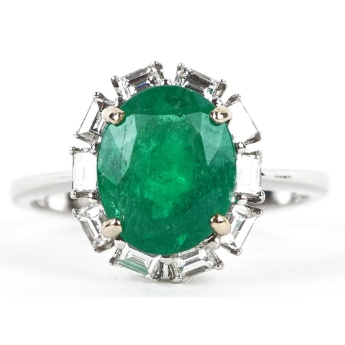 3107 - An 18ct white gold emerald and baguette cut diamond cluster ring, total diamond weight 0.41 carat, t... 