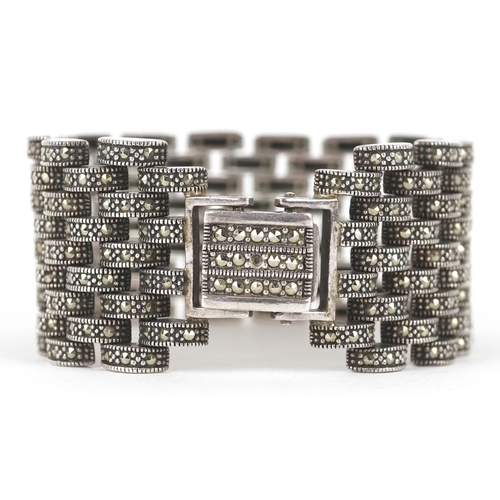 3132 - An Art Deco style silver marcasite nine row bracelet, 18cm in length, 75.3g.