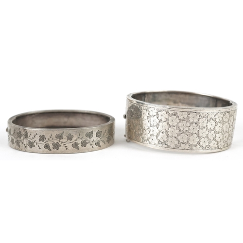 3163 - A Victorian silver bangle with engraved floral decoration, Birmingham 1876 together with a similar e... 