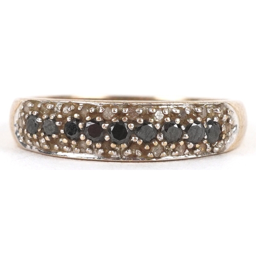 3195 - A 9ct gold black and white diamond three row half eternity ring, size P, 2.1g.