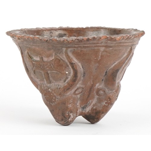 1501 - A Minoan style pottery bull and axehead cup, 6cm high.