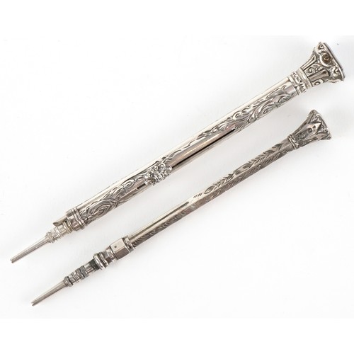 62 - Two unmarked silver cased engraved propelling pencils, one combined with a fountain pen, the largest... 