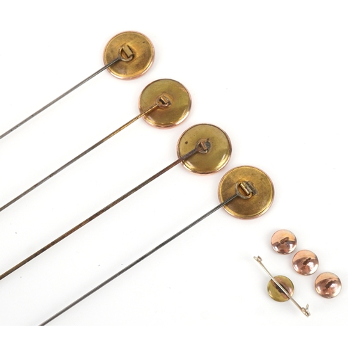 1044 - A set of four gold plated and mother-of-pearl hatpins, buttons and a broken brooch, the pins 24.5cm ... 