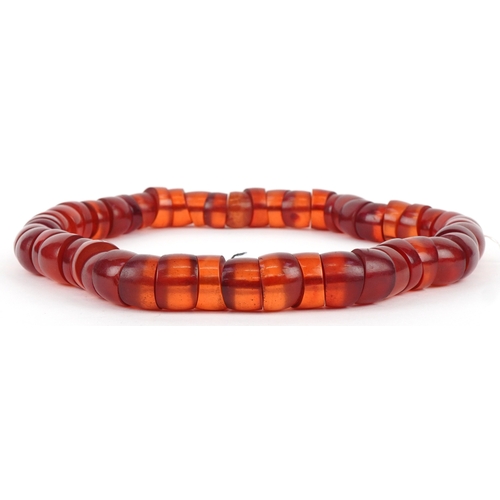 3516 - A large cherry amber coloured segmented necklace, 60cm in length x 2.5cm wide, 445.0g.