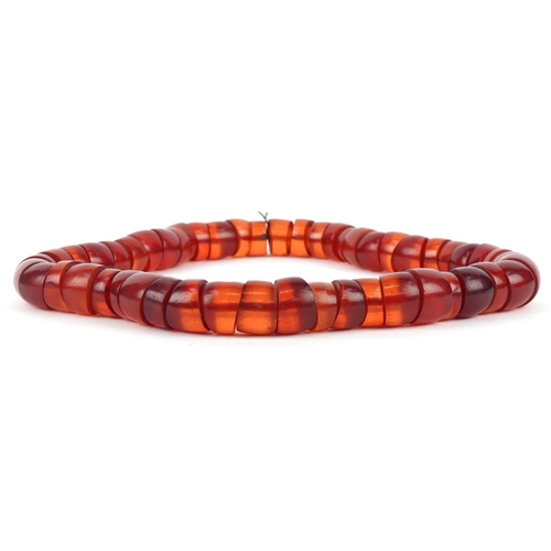 3516 - A large cherry amber coloured segmented necklace, 60cm in length x 2.5cm wide, 445.0g.