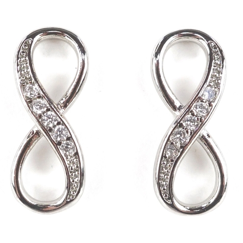 3435 - A silver infinity jewellery suite set with clear stones comprising necklace, bracelet and stud earri... 