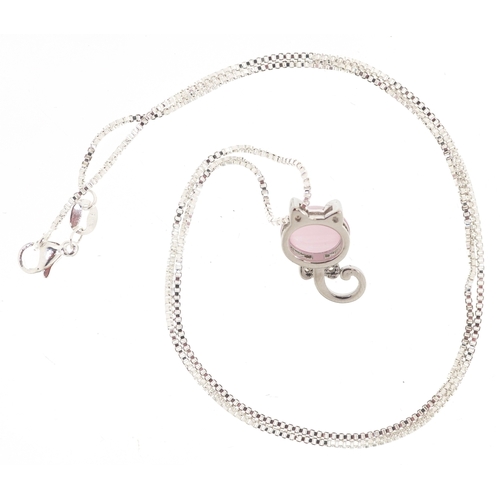 3451 - A silver and pink cat's eye pendant on chain and matching stud earrings in the form of cat heads, th... 