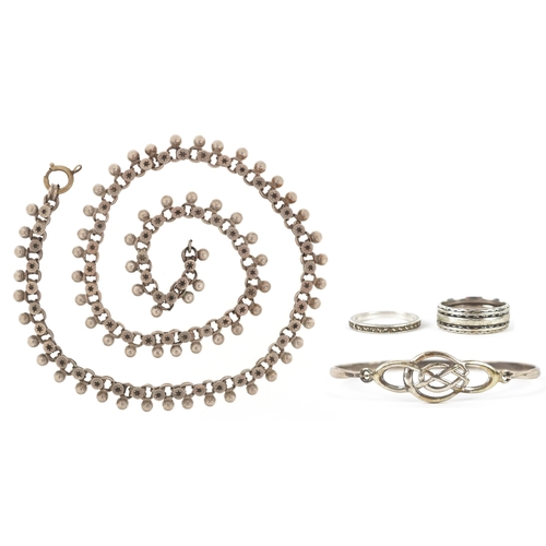 3268 - Silver jewellery comprising a Past Times Celtic design bangle, two eternity rings and a Middle Easte... 