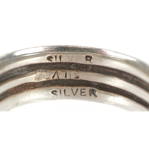 3268 - Silver jewellery comprising a Past Times Celtic design bangle, two eternity rings and a Middle Easte... 