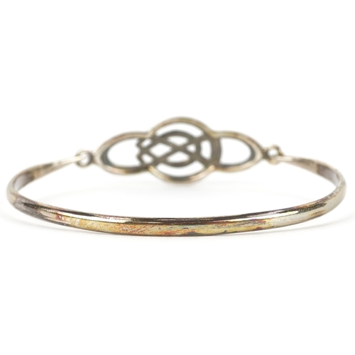 3268 - Silver jewellery comprising a Past Times Celtic design bangle, two eternity rings and a Middle Easte... 