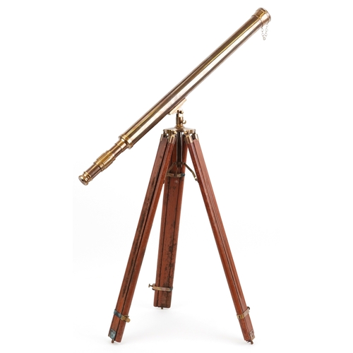1872 - A floor standing brass telescope with adjustable tripod base, the telescope 100cm in length.