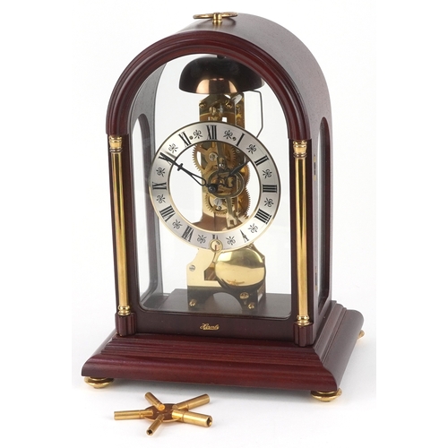 25 - A late 20th century German mahogany cased mantle clock by Hermle, the silvered dial with black Roman... 