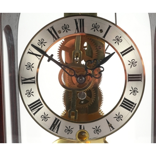 25 - A late 20th century German mahogany cased mantle clock by Hermle, the silvered dial with black Roman... 