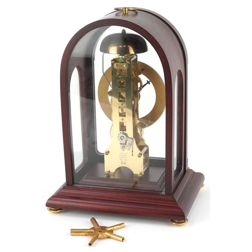 25 - A late 20th century German mahogany cased mantle clock by Hermle, the silvered dial with black Roman... 