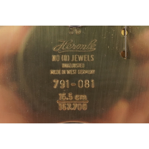 25 - A late 20th century German mahogany cased mantle clock by Hermle, the silvered dial with black Roman... 