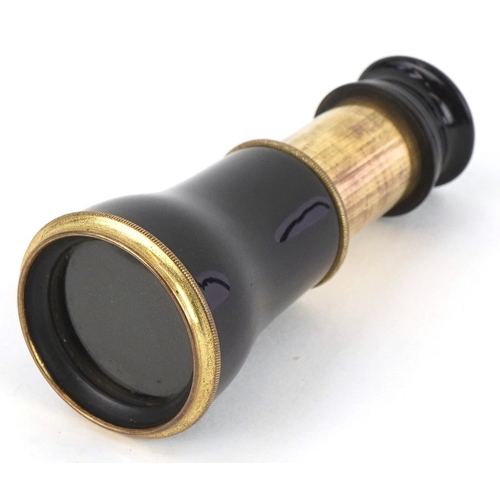 299 - An early 20th century brass and black enamel monocular, 5.5cm in length folded.