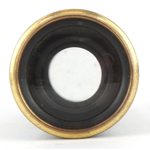 299 - An early 20th century brass and black enamel monocular, 5.5cm in length folded.