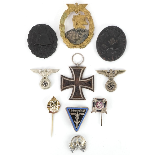 2743 - A collection of German military interest cap badges and pins etc