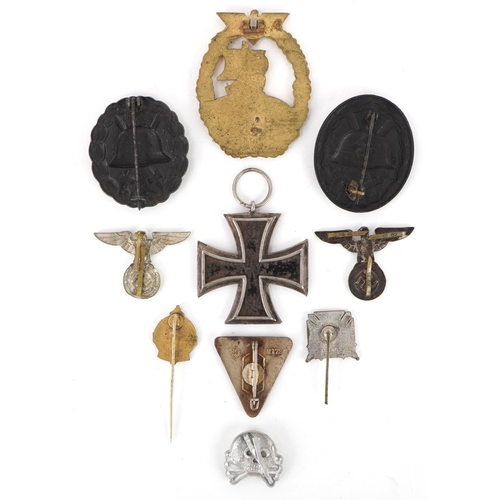 2743 - A collection of German military interest cap badges and pins etc