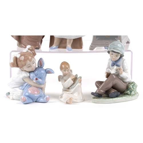 656 - Six Nao porcelain figures of young children including a boy at a desk, young girl with a teddy bear ... 