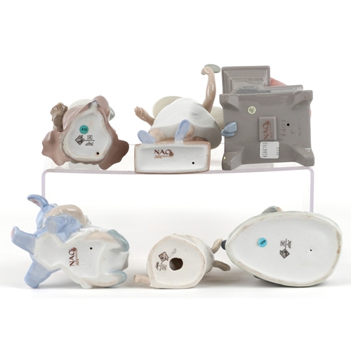 656 - Six Nao porcelain figures of young children including a boy at a desk, young girl with a teddy bear ... 