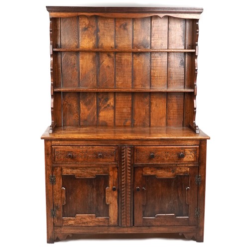 2018 - A 20th century oak dresser, the shelf back above two drawers and a cupboard, on stile supports, 205c... 