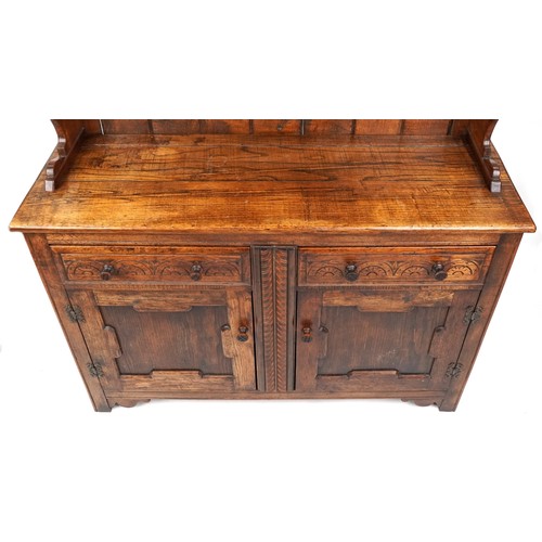 2018 - A 20th century oak dresser, the shelf back above two drawers and a cupboard, on stile supports, 205c... 