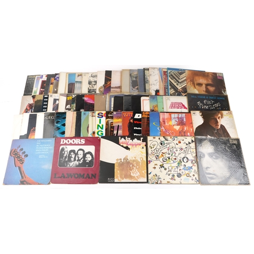 A collection of vinyl LP records including The Doors LA Woman, David ...
