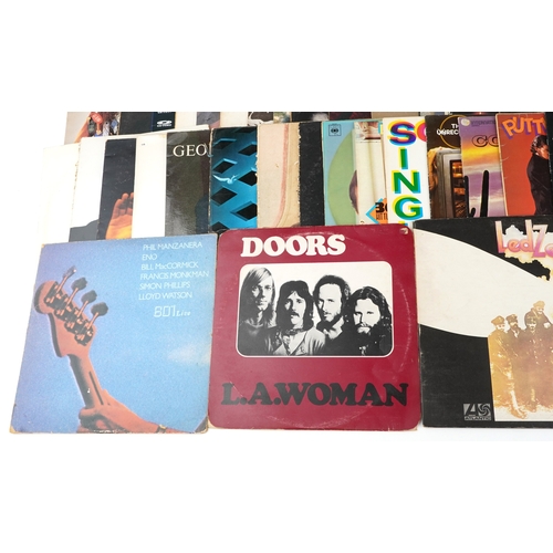 A collection of vinyl LP records including The Doors LA Woman, David ...