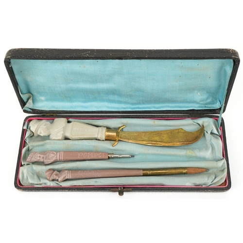 80 - A set of three lava cameo writing instruments comprising two pencils and letter opener carved with c... 