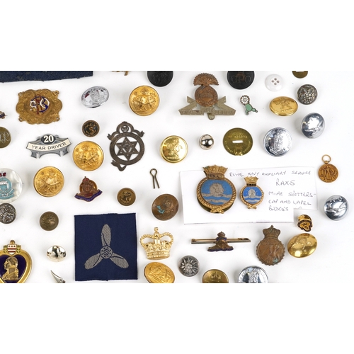 2808 - A large collection of British military interest cap badges and uniform buttons, various regiments.