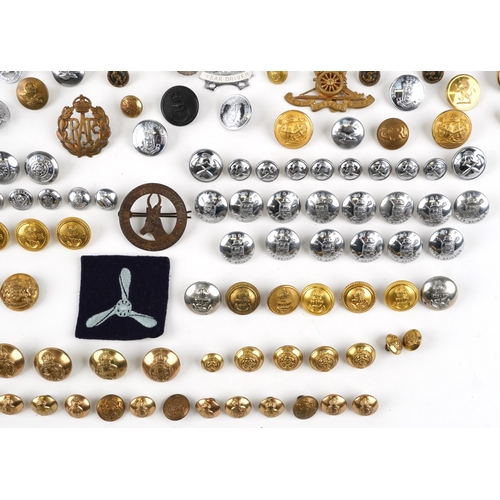2808 - A large collection of British military interest cap badges and uniform buttons, various regiments.