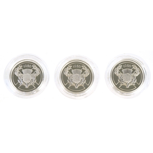 1147 - Three 1986 13th Commonwealth Games silver proof commemorative two pound coins, all in blue presentat... 