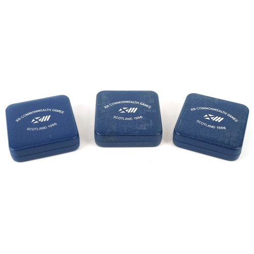 1147 - Three 1986 13th Commonwealth Games silver proof commemorative two pound coins, all in blue presentat... 