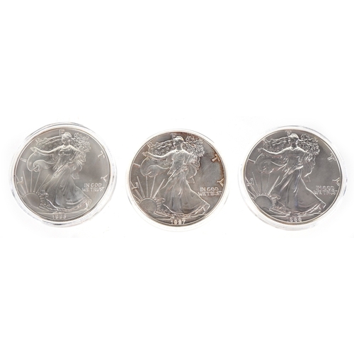 1114 - Three USA one ounce fine silver walking Liberty dollars including a matte proof example, dates 1987,... 