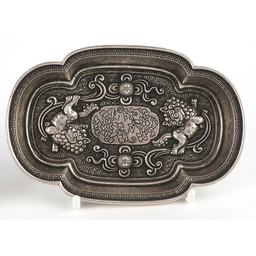 1834 - Three Chinese white metal dishes, each cast with floral decoration and animalia, the largest 12cm wi... 