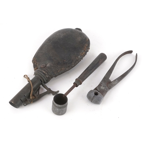 2827 - An antique leather powder flask, a bullet/shot mould and shot measure, the largest 17cm in length.
