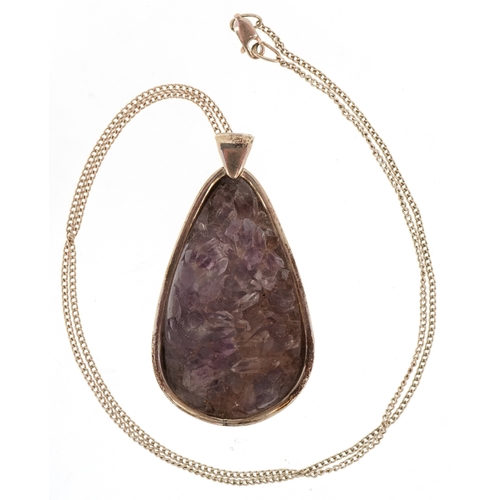 3196 - An unmarked silver amethyst pendant on a silver necklace, 5.9cm high and 50cm in length, total 38.4g... 