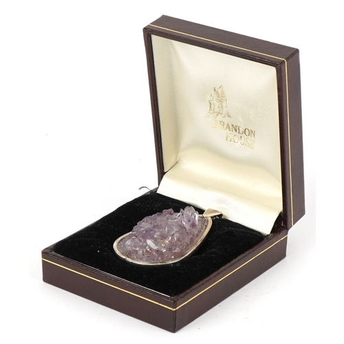 3196 - An unmarked silver amethyst pendant on a silver necklace, 5.9cm high and 50cm in length, total 38.4g... 