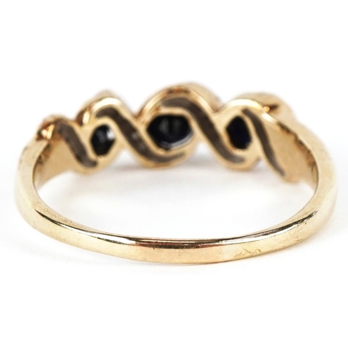 3229 - An 9ct gold sapphire and diamond crossover ring, size R, 3.0g.