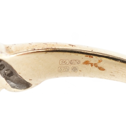 3229 - An 9ct gold sapphire and diamond crossover ring, size R, 3.0g.