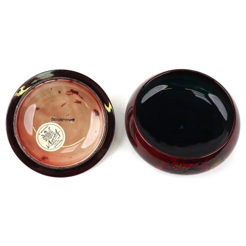 179 - A Moorcroft pottery pot and cover hand painted in the Hibiscus pattern, bearing paper label to the b... 