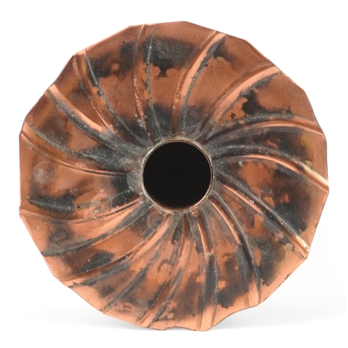 Sam Fanaroff, an Arts & Crafts style copper vase having a fluted spiral top, initialled SF to the ba... 